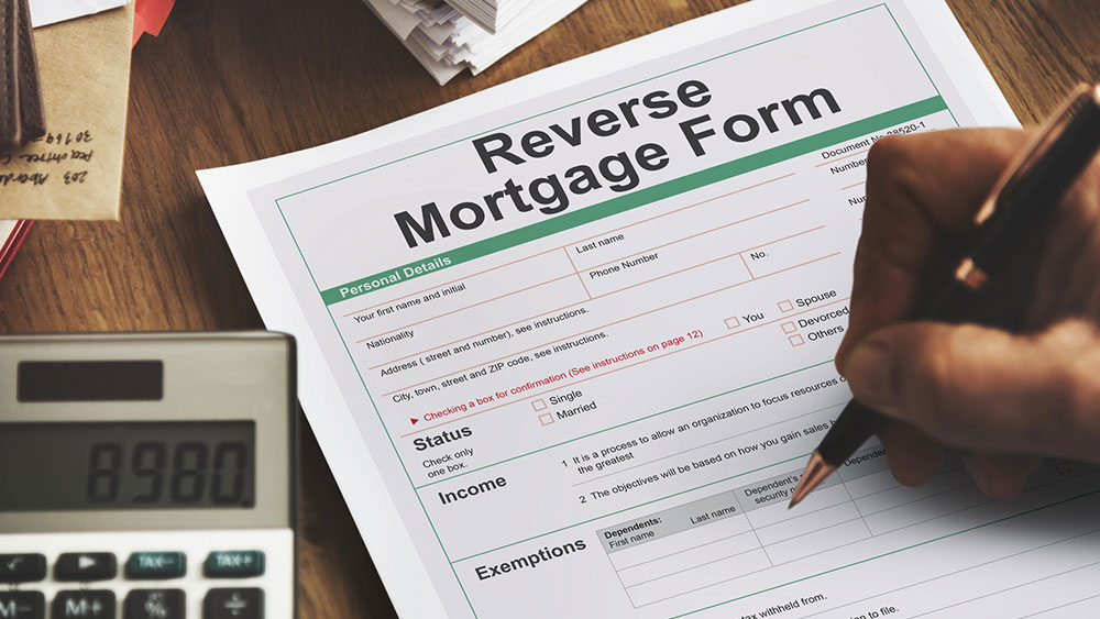 Person filling out a Reverse Mortgage paper form